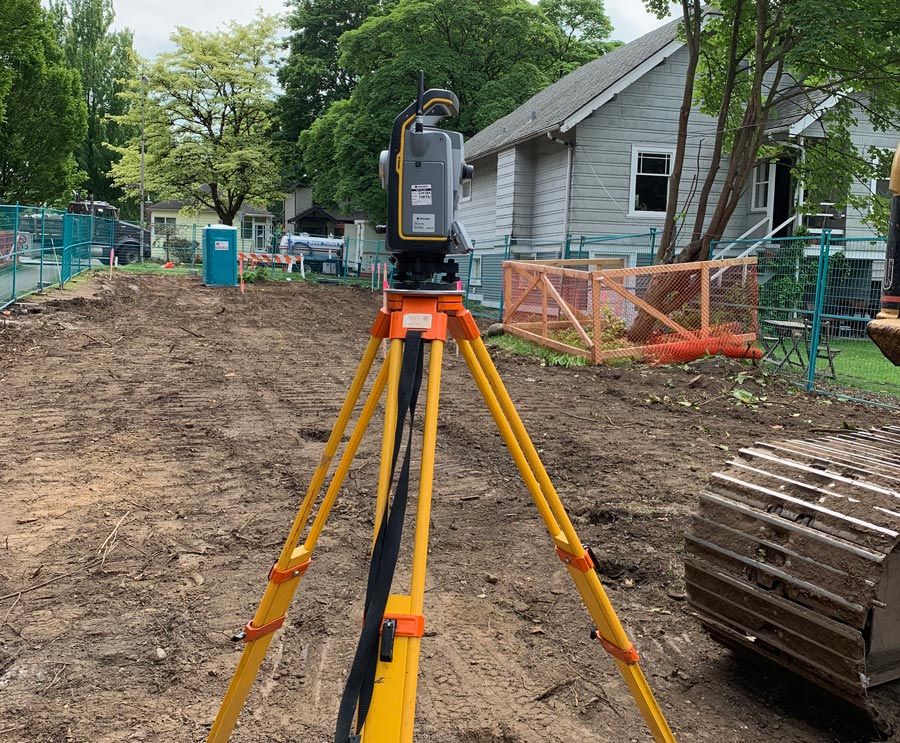 Picture of a land surveying equipment by a backyard